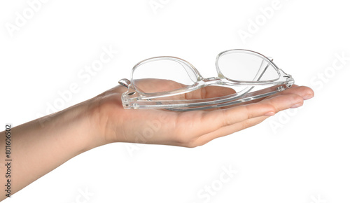 Woman holding glasses with transparent frame on white background, closeup