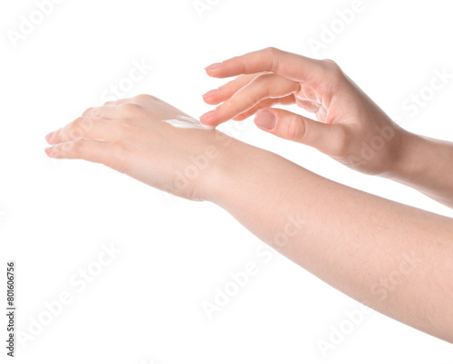 Woman applying cream on her hand against white background, closeup