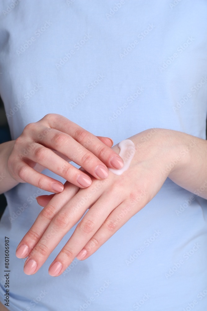 Woman applying cream on her hands, closeup Woman applying cream on her hands, closeup