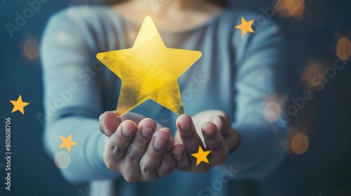 A photo of a person holding a glowing yellow star in the palm of their hand with a dark blue background with stars twinkling in the background