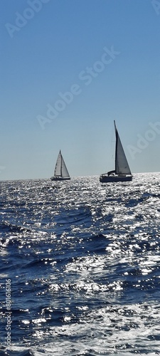 Yacht sailing on opened sea. Sailing boat. Yachting photo. Sailing photo. Yachting at windy day. Yacht. Sailboat. Sailing. Ship yachts with sails in the open Sea. Sailboat in the sea in the sunlight 