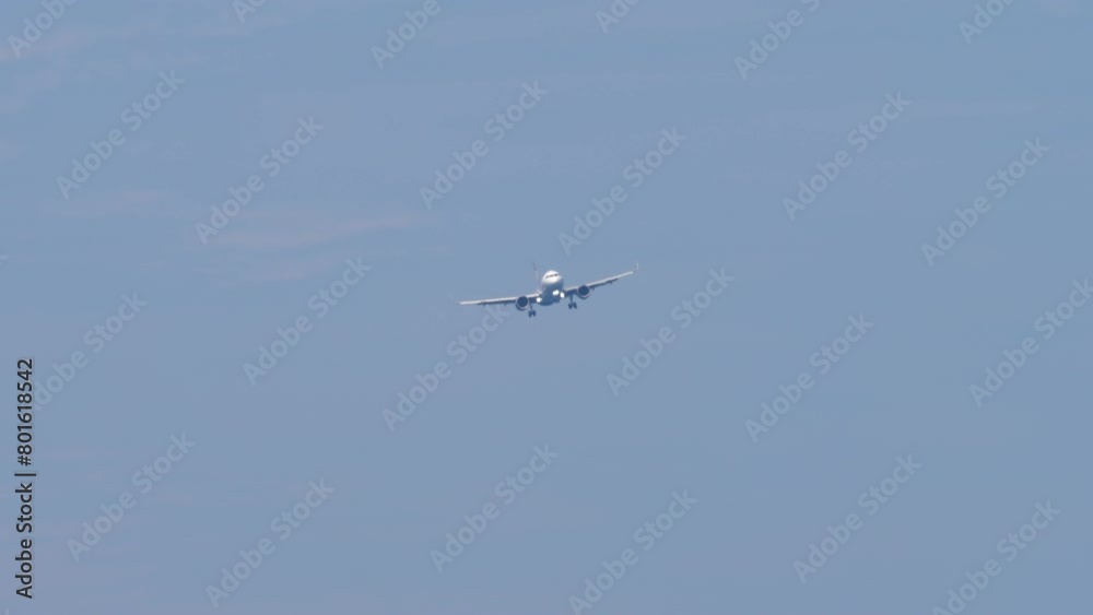Jet aircraft with an unrecognizable livery approaching landing, long shot. Travel concept Jet aircraft with an unrecognizable livery approaching landing, long shot. Travel concept