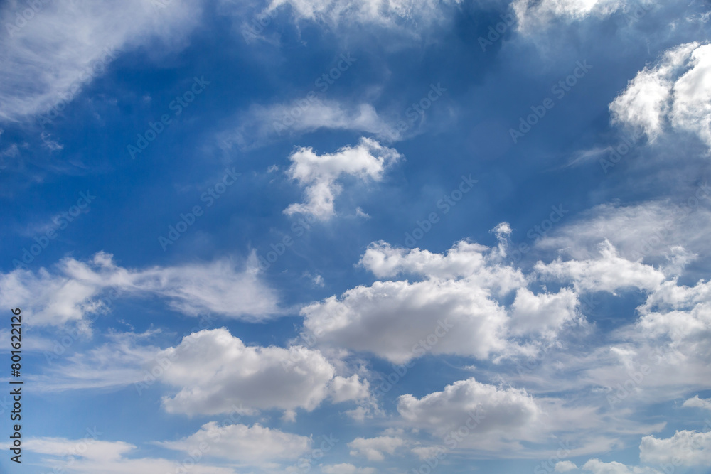 Blue sky with puffy cloud formations, natural background Blue sky with puffy cloud formations, natural background