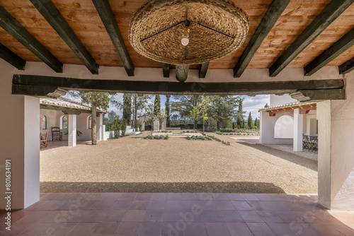a gallery with wooden ceilings in the patio of an Andalusian farmhouse style house