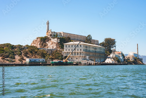 Clear day view of Alcatraz Island in San Francisco Bay, California, USA, showcasing the former prison complex with main cellhouse, lighthouse, dock, and historic structures.