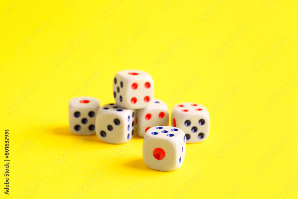 Many white game dices on yellow background, closeup Many white game dices on yellow background, closeup