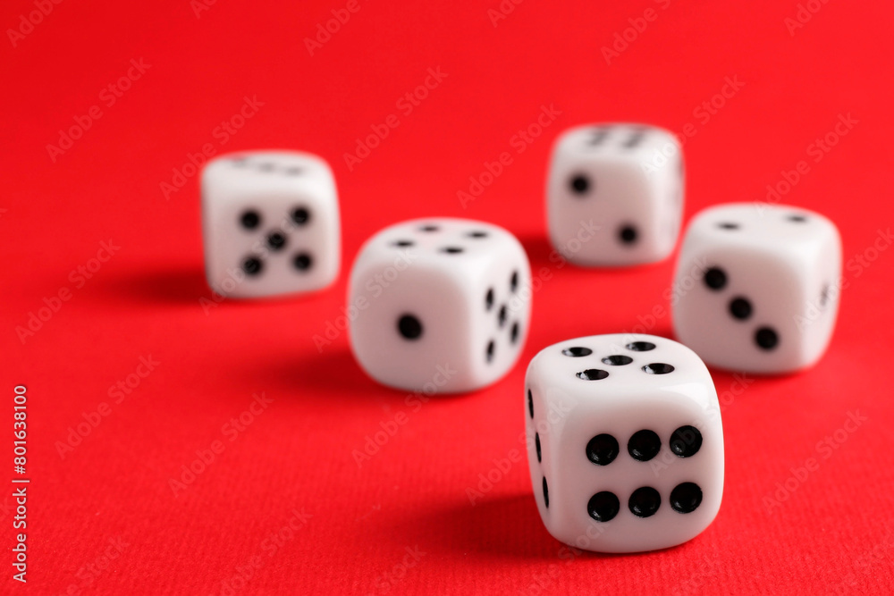 Many white game dices on red background, closeup Many white game dices on red background, closeup