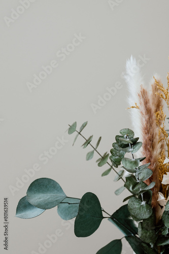 Dried floral bouquet with eucalyptus in a ceramic vase