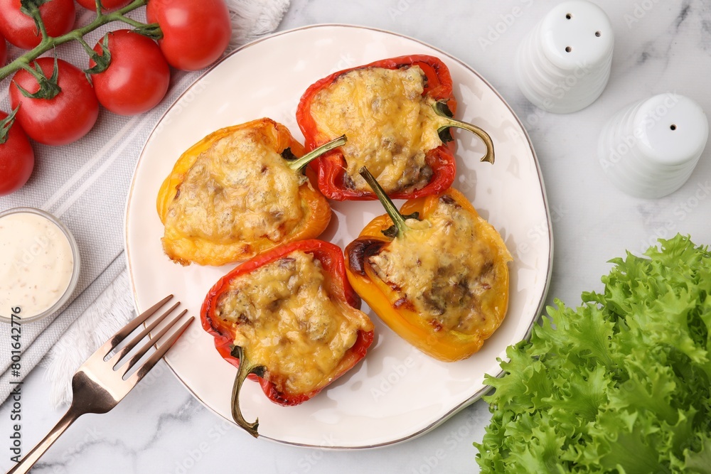 Delicious stuffed peppers served on white marble table, flat lay