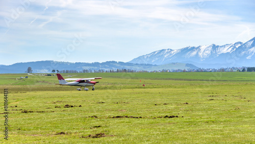 Small airplane on the grass airfield in Nowy Targ