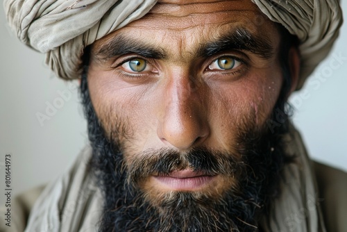 A man with a beard and a turban has a blue eye photo