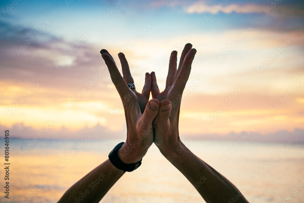 hand in lotus mudra at sunset