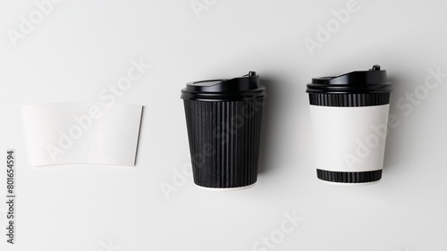 Black coffee cup and white paper sleeve, product packaging, flat lay design photo