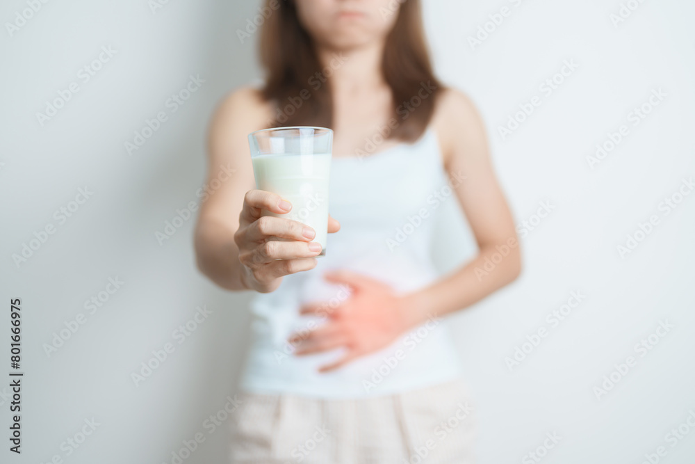 Lactose intolerance and Milk allergy concept. woman hold Milk glass and having abdominal cramps and pain when drink Cow Milk. Symptom stomach ache, Dairy intolerant, Nausea, Bloating, Gas and Diarrhea Lactose intolerance and Milk allergy concept. woman hold Milk glass and having abdominal cramps and pain when drink Cow Milk. Symptom stomach ache, Dairy intolerant, Nausea, Bloating, Gas and Diarrhea
