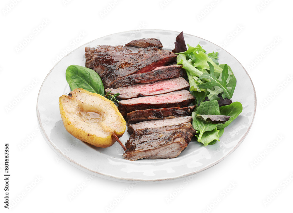 Pieces of delicious roasted beef meat, caramelized pear and greens isolated on white