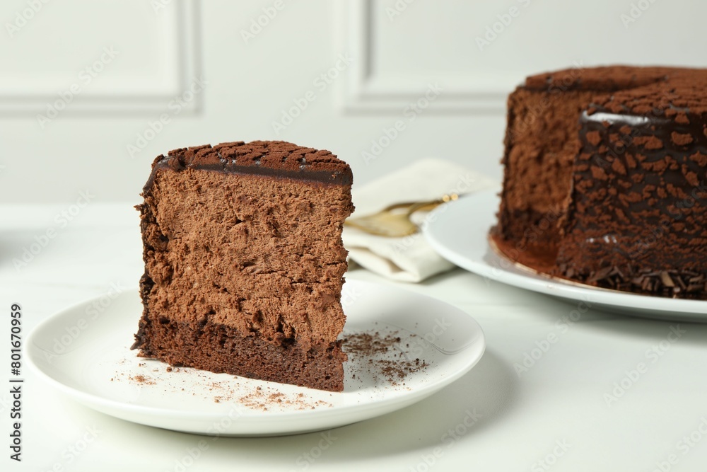 Piece of delicious chocolate truffle cake on white table Piece of delicious chocolate truffle cake on white table