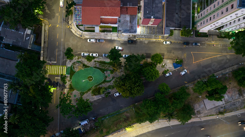 Small square in the city at sunset when street lighting is automatically turned on photo