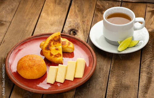 Arepa, almojabana, cheese and hot aguapanela - Typical Colombian breakfast photo