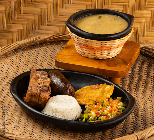 Traditional Colombian gastronomy - Wheat cuchuco - Roast peasant boyacense baked pork rib and blood sausage. photo