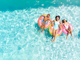 Diverse family enjoy a pool day, with copy space