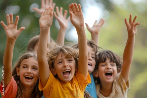 Group of happy children raising their hands up in the air and laughing