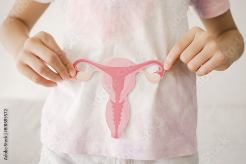 Preteen girl hands holding uterus, teen health, PCOS, first period concept photo