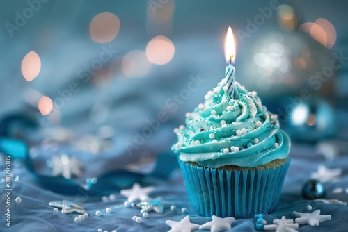 cupcake with candle and sprinkles © STOCKYE STUDIO