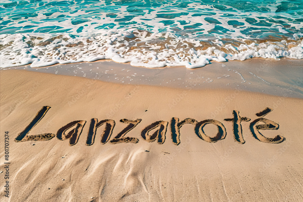 Fototapeta premium Lanzarote, Spain written in the sand on a beach. Spanish tourism and vacation background