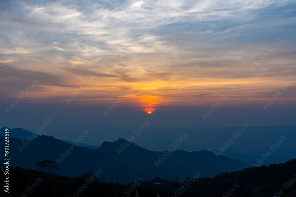Scenic mountain landscape and bright sunrise or sunset sky over the horizon. Natural skyscape background