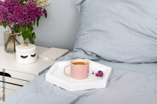 Tray with coffee on the bed, cozy morning
