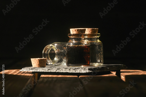 Magic potion bottle on the old wooden table background front view. Witchcraft concept.