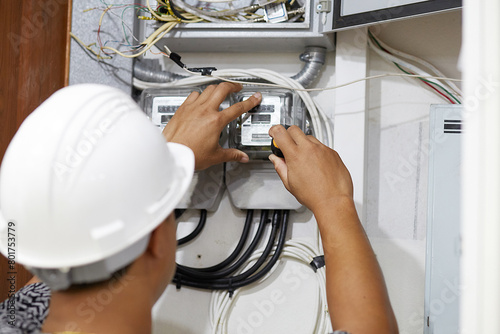 Electrician is repairing and checking electric meters. Close up. Selective focus. photo