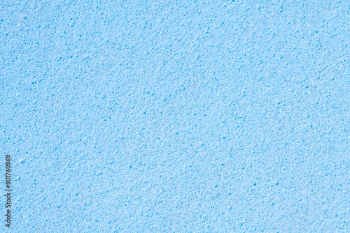 Blue background, rough sponge texture, macro shot design photo