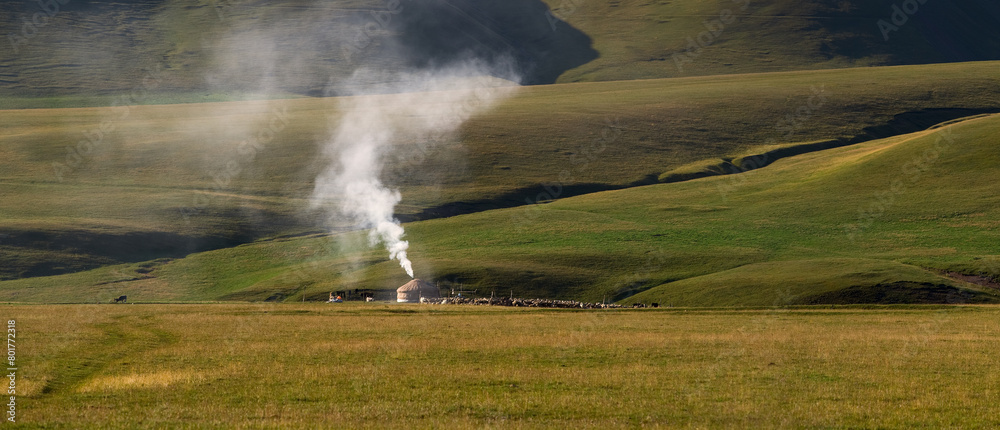 Traditional nomad dwelling - a yurt at the foot of the plateau hills on a summer morning Traditional nomad dwelling - a yurt at the foot of the plateau hills on a summer morning
