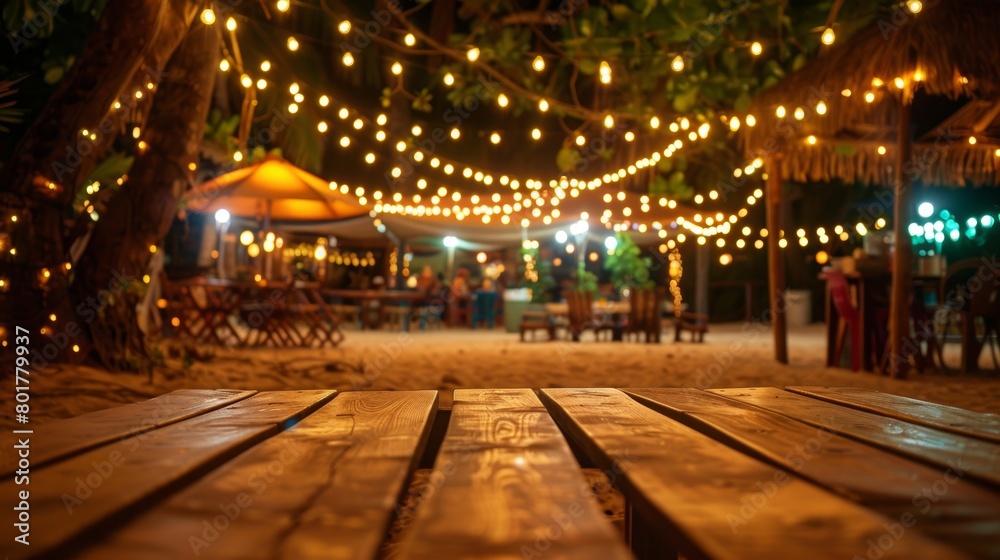 An inviting beachfront cafe at night adorned with vibrant string lights creating a festive mood.