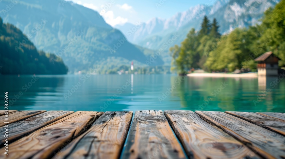 A calm and peaceful wooden deck by a crystal clear alpine lake surrounded by majestic mountains in a serene setting.