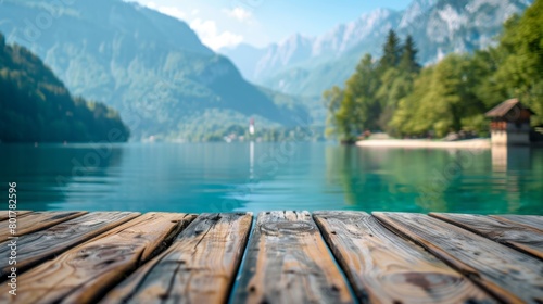 A calm and peaceful wooden deck by a crystal clear alpine lake surrounded by majestic mountains in a serene setting.