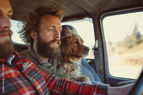 Man with beard and dog sitting in back seat of truck on a scenic road trip © SHOTPRIME STUDIO