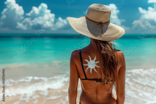 Woman in Sun Hat Facing Turquoise Beach