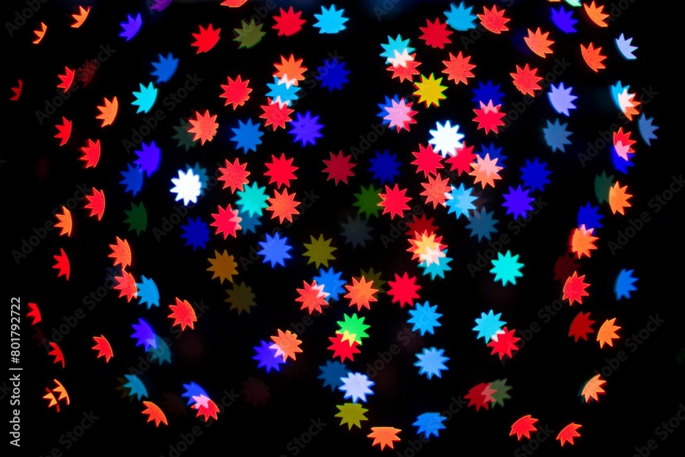 Colorful glitter polygon star bokeh sequin confetti on black background