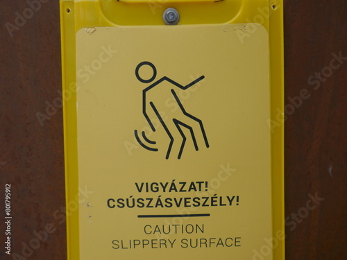 Caution slippery surface sign with English and Hungarian Vigyázat, csúszós felület photo