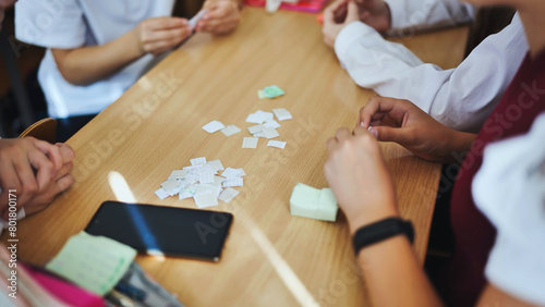 Children play with homemade small papers.