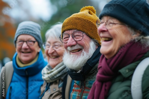 Portrait of happy senior people in the autumn park. Elderly people outdoor.