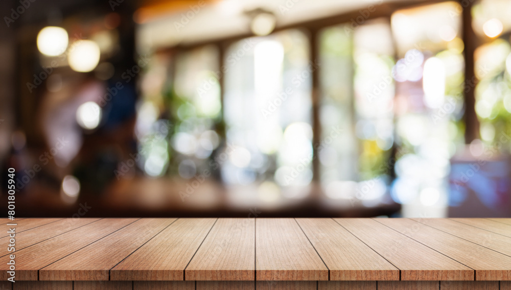 Empty wooden table top with lights bokeh on blur restaurant background. Empty wooden table top with lights bokeh on blur restaurant background.