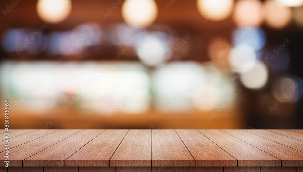Empty wooden table top with lights bokeh on blur restaurant background.