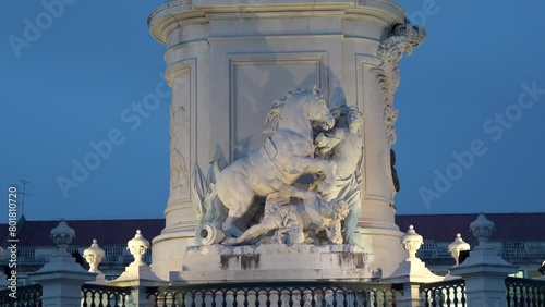 Lisbon, Commerce Square, King Jose's Statue's Base Details zooming in during dusk. Beautiful white marble sculpture of a horse standing up in two legs in motion with two people around. photo