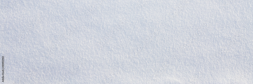 Natural snow texture. Smooth surface of clean fresh snow. Snowy ground. Winter background with snow patterns. Closeup top view. Wide panoramic texture for background and design.