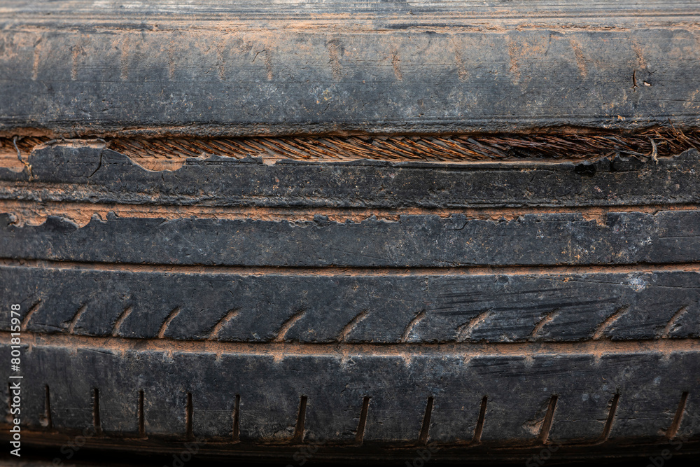 Old tires stacked in a heap, forming a textured pattern