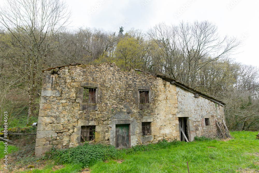 large abandoned and isolated semi-demolished stone house in the middle of the mountain. Cantabria, Spain