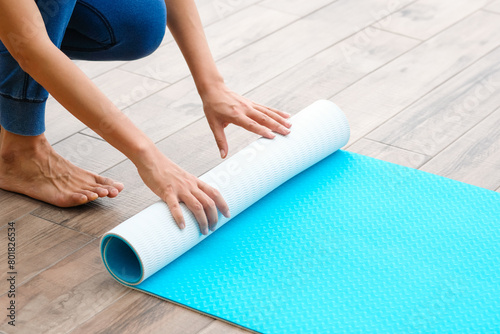 Women are yoga mat blue rolls. Fitness room